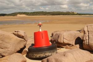 Misplaced buoy on the beach on the other side