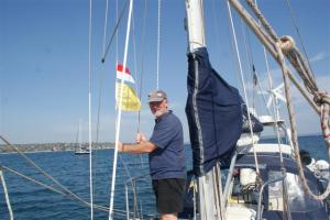 Bill hoisting the Indonesian courtesy flag plus the 'Q' flag