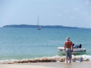 Bill brought the dinghy up the beach while Camomile watched
