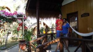 Tom and Son outside their little cottage