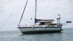 The topping lift going out to the reef is just visible