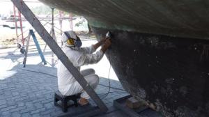 Bill sanding down the old antifoul on the keel