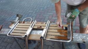 Giving bathing platform a coat of teak oil