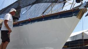 Clamping a section of the rubbing strake in position