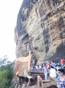 Queue of people with spiral staircase in the back ground.