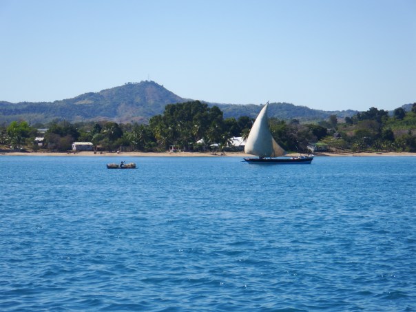 A pirogue sailing up the channel
