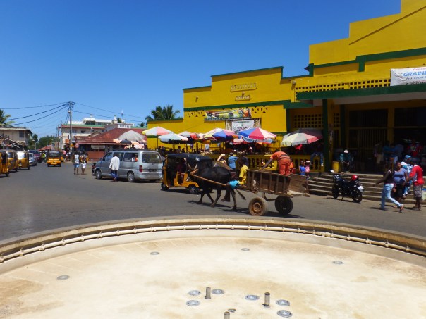 Street life with the market on the right and a roundabout in front of me